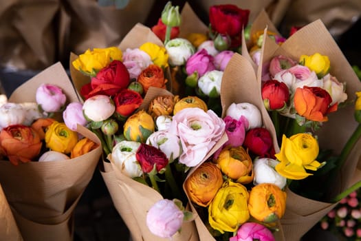 Colorful persian buttercup flowers or Ranunculus asiaticus bouquets in a greek flower shop. Horizontal. Close-up.