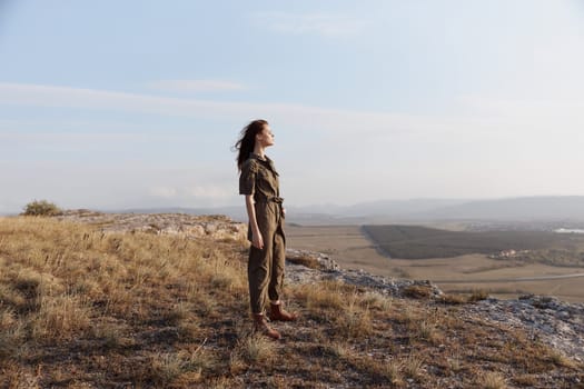 Woman standing atop hill gazing over beautiful valley in the distance travel beauty nature landscape peaceful beauty summertime scenery trip vacation outdoor adventure sunrise majesty overlook retreat