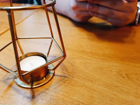 man hand hold phone in hands watch candle holder bar cafe cozy sitting company together business busy dialog technology addiction social networking. High quality photo