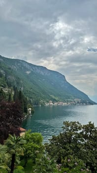 Lake Como, Italy. Scenic view of mountains and lake features lush greenery, tranquil waters, under cloudy sky with lush greenery and tranquil waters, nature landscape concept, showcasing a beautiful nature