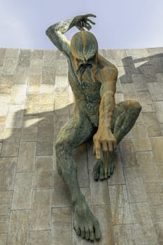 Newcastle, UK - Apr 14, 2025 - Stunning view of Bronze River God Tyne Sculpture is mounted on an external wall with blue sky background of The Newcastle Civic Centre Building at Newcastle Upon Tyne. use it as your Wallpaper, Poster and Copy space, Selective focus.