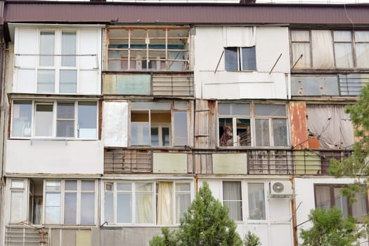Ruined old poor dirty house with balconies