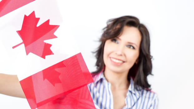 Happy woman is holding two Canadian flags. National pride. Election. Patriot