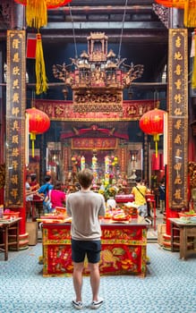Kuala Lumpur, Malaysia - February 16, 2025: The colorful Sin Sze Si Ya Temple, lit by lanterns and adorned with intricate decorations. Vibrant offerings and lively atmosphere characterize the site