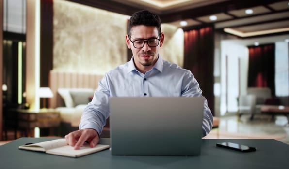 Business Travel With Laptop In Hotel. Businessman In Luxury Room