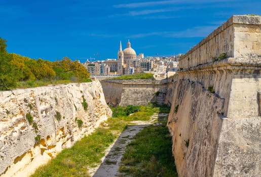 Beautiful view of Valletta through fortified walls of Manoel Island.