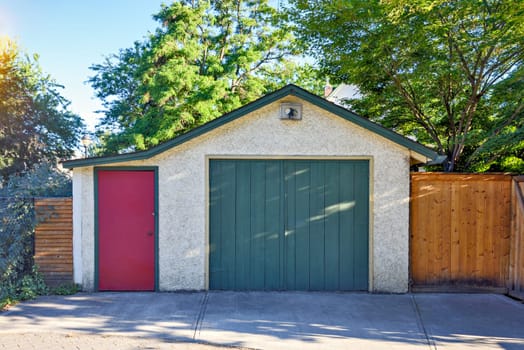 Old garage and entrance door from backstreet side of residential house.