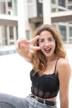 happy young woman showing victory sign