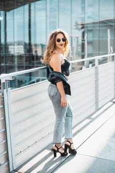 smiling young woman with sunglasses in the city