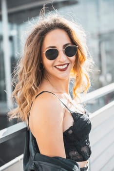 happy young woman with sunglasses in the city