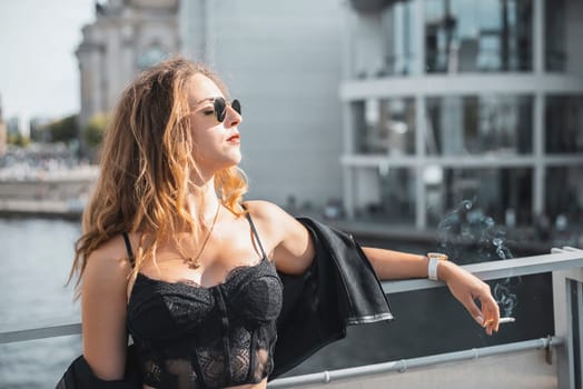relaxed young woman with cigarette enjoying sun