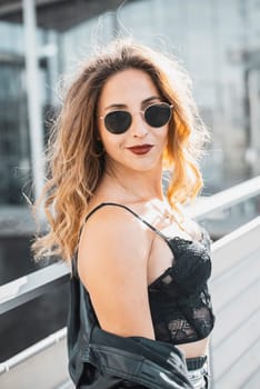 smiling young woman with sunglasses in the city