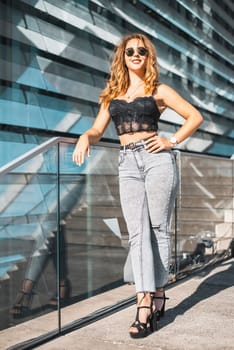 happy young woman with sunglasses in the city