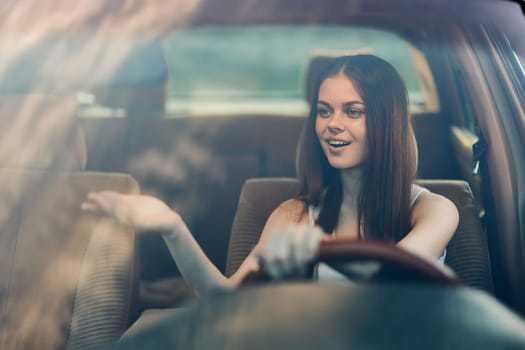 Cheerful young woman driving a car, exuding joy and confidence, dressed stylishly, against a green background, portraying the themes of freedom, adventure, and enjoyment.