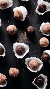 Assortment of fine chocolate candies, white, dark, and milk chocolate Sweets background. Copy space. Top view.