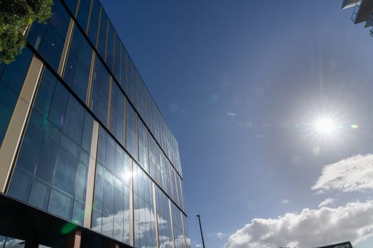 Tauranga urban street scene sun flare above exterior windows of urban commercial building new Zealand.