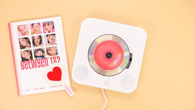 Twice Between 1 and 2 mini Album Box set on yellow. Red music disc in white cd player. South Korean girl group Twice. Space for text. Gatineau, QC Canada - December 27 2022
