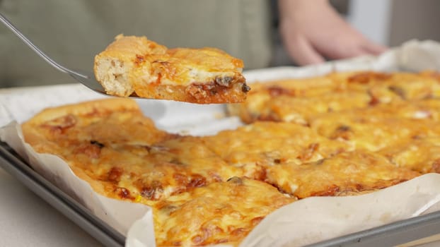 Homemade square pizza with cheese and sausage topping served on wooden table Square pizza, full cheese spread organic pizza healthy pizza.