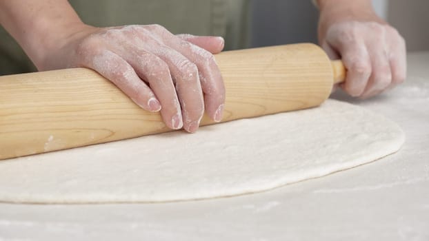 Hands Shaping the dough into ball by hand. chef Preparing the dough for baking pizza bread in the restaurant, baking.