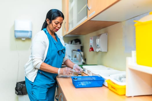 Nurse wearing gloves preparing medication for residents in the pharmacy of a nursing home