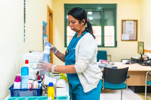 Nurse wearing gloves and preparing medical equipment on a cart in a nursing home, ensuring safety and cleanliness for elderly patients