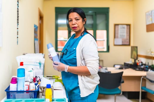 Nurse wearing gloves and holding medical equipment, preparing treatment in a nursing home