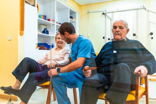Nurse helping elderly woman with leg exercises, promoting mobility and well being in a bright nursing home environment