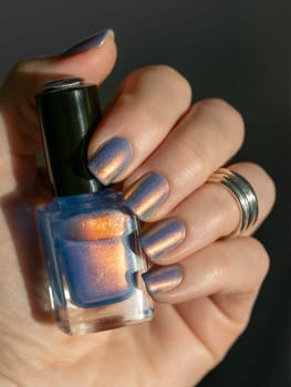 Close-Up of Nail Polish on Well-Groomed Nails with chrome powder effect nail polish in blue and pink colors
