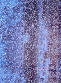 Newcastle, UK - Apr 11, 2025 - Cracks on the glass surface background. Texture of broken tempered glass pane too many small irregular shape pieces holding together. Detail of cracked broken glass cracked by impact, use it as your Wallpaper, Poster and Copy space, Selective focus.