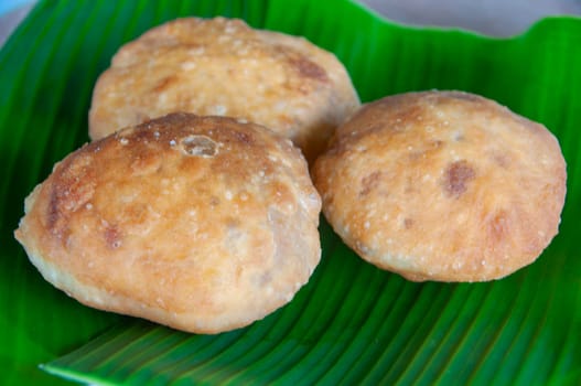 Side view of North Borneo home made traditional green bean cake with banana leaf background. Asian food concept.
