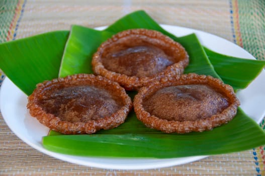 Side view of North Borneo home made traditional kuih penjaram cake with banana leaf background. Asian food concept.