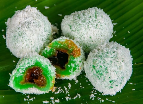 Top view of delicious traditional onde onde with gula melaka filling and coconut coating.