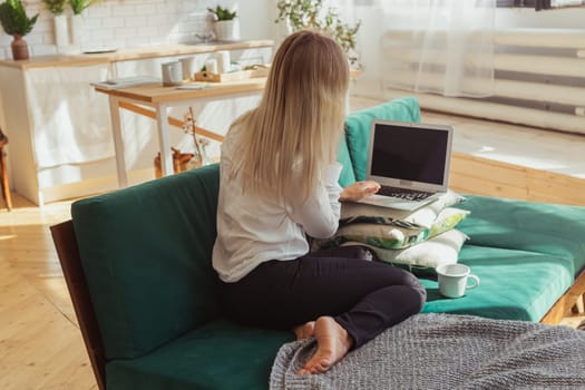 Woman talking on smartphone while working remotely. Communication, freelance and modern home lifestyle theme