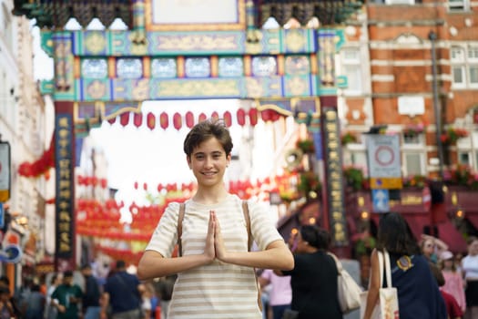 Teenage girl cheerfully greets the lively and vibrant atmosphere of Chinatown, fully embodying a true spirit of cultural appreciation amidst a plethora of colourful and festive decorations.