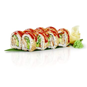 Freshly prepared sushi rolls, featuring eel, avocado, cucumber, and a drizzle of spicy sauce, served on a banana leaf