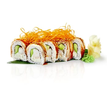 Delicious dragon roll sushi, featuring eel, shrimp, avocado, and cream cheese, topped with crispy fried onions and sesame seeds, served on a banana leaf