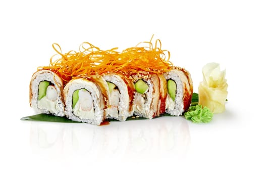 Sushi rolls with eel, avocado, cream cheese, shrimp and sesame seeds, garnished with crispy carrot and served on a banana leaf with wasabi and pickled ginger