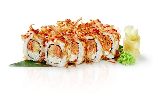 Freshly prepared sushi rolls, featuring smoked salmon, cream cheese, and bonito flakes, are served on a white background with wasabi and gari