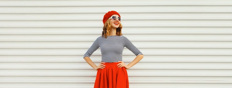 Beautiful happy smiling young woman, pretty girl in red skirt, french beret, heart shaped glasses posing on white background