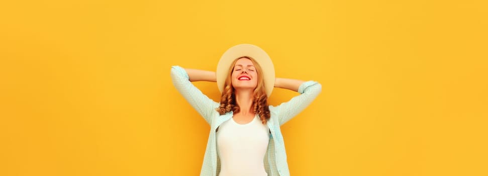 Summer vacation, fashion, lifestyle. Happy joyful relaxed young woman enjoying sunny warm day in tourist straw hat, standing on bright yellow background