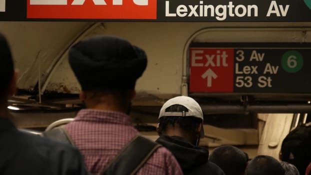 New York City, United States - 31 Aug 2023: Subway station interior, Lexington avenue sign. Manhattan underground metropolitan. Metro transport navigation. Public passenger railway. People, escalator.