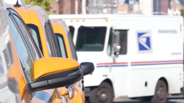 New York City, United States - 1 Sept 2023: Row of yellow taxi cars on street, Queens. Taxi cab on avenue, Long Island. Medallion taxicab. Manhattan Midtown urban skyline cityscape. High-rise building