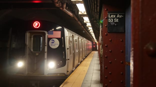 New York City, United States - 30 Aug 2023: Subway station, underground metropolitan platform sign. Metro train, railway public transport. Text signboard: Lexington Avenue. Lex Av. Midtown Manhattan.