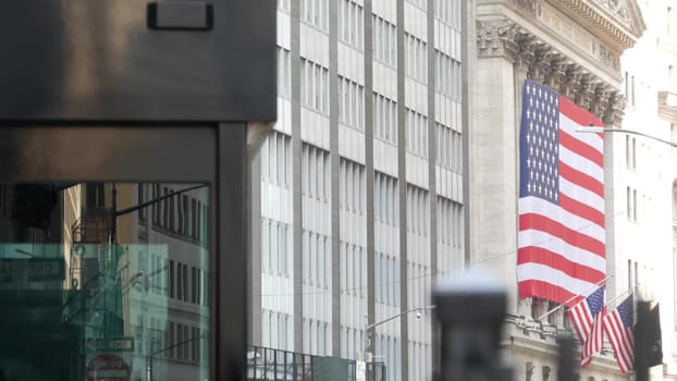 New York City, United States - 9 Sept 2023: Lower Manhattan Downtown Financial District urban architecture. Huge big American flag. Wall street Stock Exchange building, USA Stock Market trading.