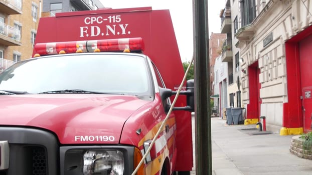 New York City, United States - 30 Aug 2023: NYFD car, USA fire department truck, american firefighters vehicle or fire fighter engine on NYC street. Firemen station red gates, FD house or hall. Queens