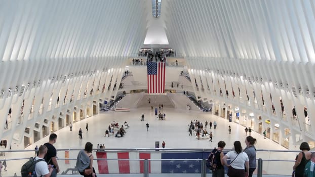 New York City, United States - 10 Sept 2023: World Trade Center Oculus transport hub architecture. Manhattan Downtown Financial District, USA urban life. People. September 11 remembrance american flag