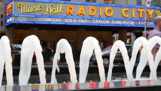 New York, United States - 10 Sept 2023: Manhattan Midtown street. Radio City Music Hall, Rockefeller Center, USA landmark. People pedestrian and urban traffic on 6 Sixth Americas avenue crossroad, NYC