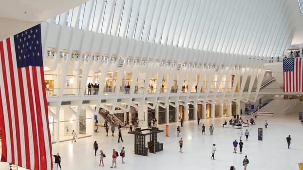 New York City, United States - 10 Sept 2023: World Trade Center Oculus transport hub architecture. Manhattan Downtown Financial District, USA urban life. People. September 11 remembrance american flag