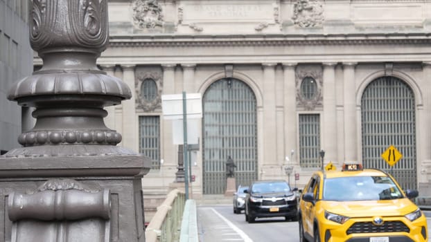 New York City, United States - 4 Sept 2023: Grand Central Terminal railway station building, 42 street. Manhattan Midtown. Yellow taxi cab, car transport on bridge, USA. American urban road traffic.
