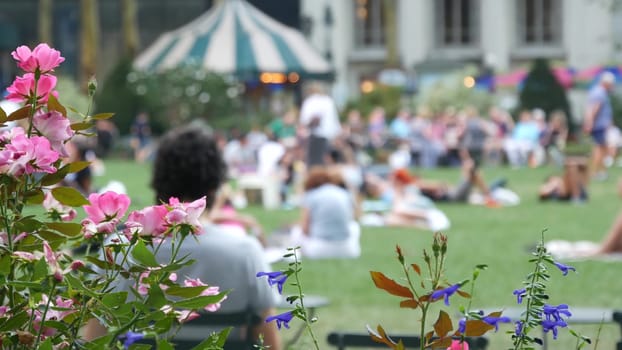 New York City, United States - 5 Sept 2023: Manhattan Midtown Bryant Park with Public library, 42 street and 5th Fifth 5 avenue. NYC in USA. Chair and table in summer greenery. People on grass lawn.